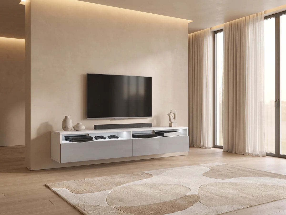 Meuble TV Blanc et Gris Brillant avec LED 180 cm REDNAW dans un salon minimaliste lumineux aux tons chauds, vue de face