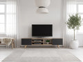 Meuble TV en bois noir MOSTIA dans un salon scandinave lumineux aux tons chauds, vue de face